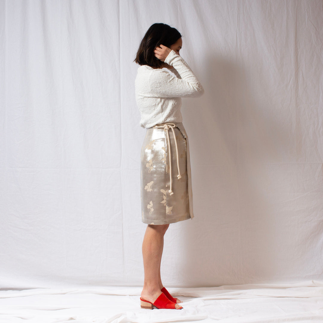 That’s a Wrap Mini straight silhouette silk skirt worn at the knee